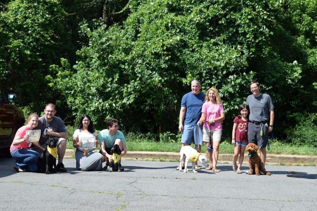 taking picture with dog owners during their group classes in Vienna, VA